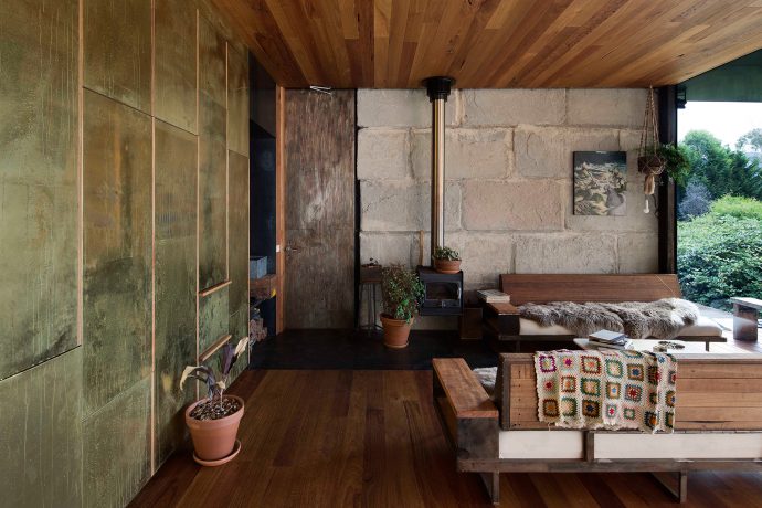 Textures of brass, concrete and wood intermingle in the house's open plan layout. Photo by Ben Hosking.
