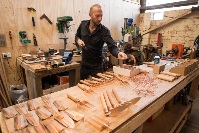 Work in progress: planters, trowels, scoops and spades – Travis adds handles made from sustainably managed Spotted Gum eucalyptus to the collection to the copper parts. Photo by Fred Kroh.