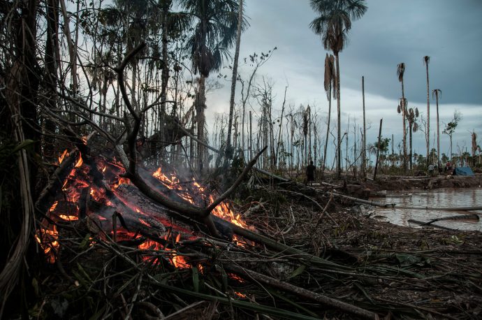 A fire burns on the site of a mining operation in the Madre de Dios region. The clear cutting of forests to expose the mineral rich soils means there is a constant source of fuel for fires. Photo by Maxim Holland.