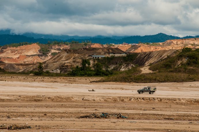 One of the typical modifi ed 4×4 trucks used by miners in the local area travels across the expanse of sediment left by mining operations. Photo by Maxim Holland.