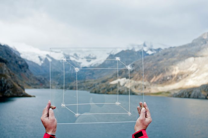 Ishmael Randall Weeks holds up his version of the ‘Carbon Cube’ to the landscape as part of Haresh Bhojwani’s project. Photo by Eduardo Valdez.